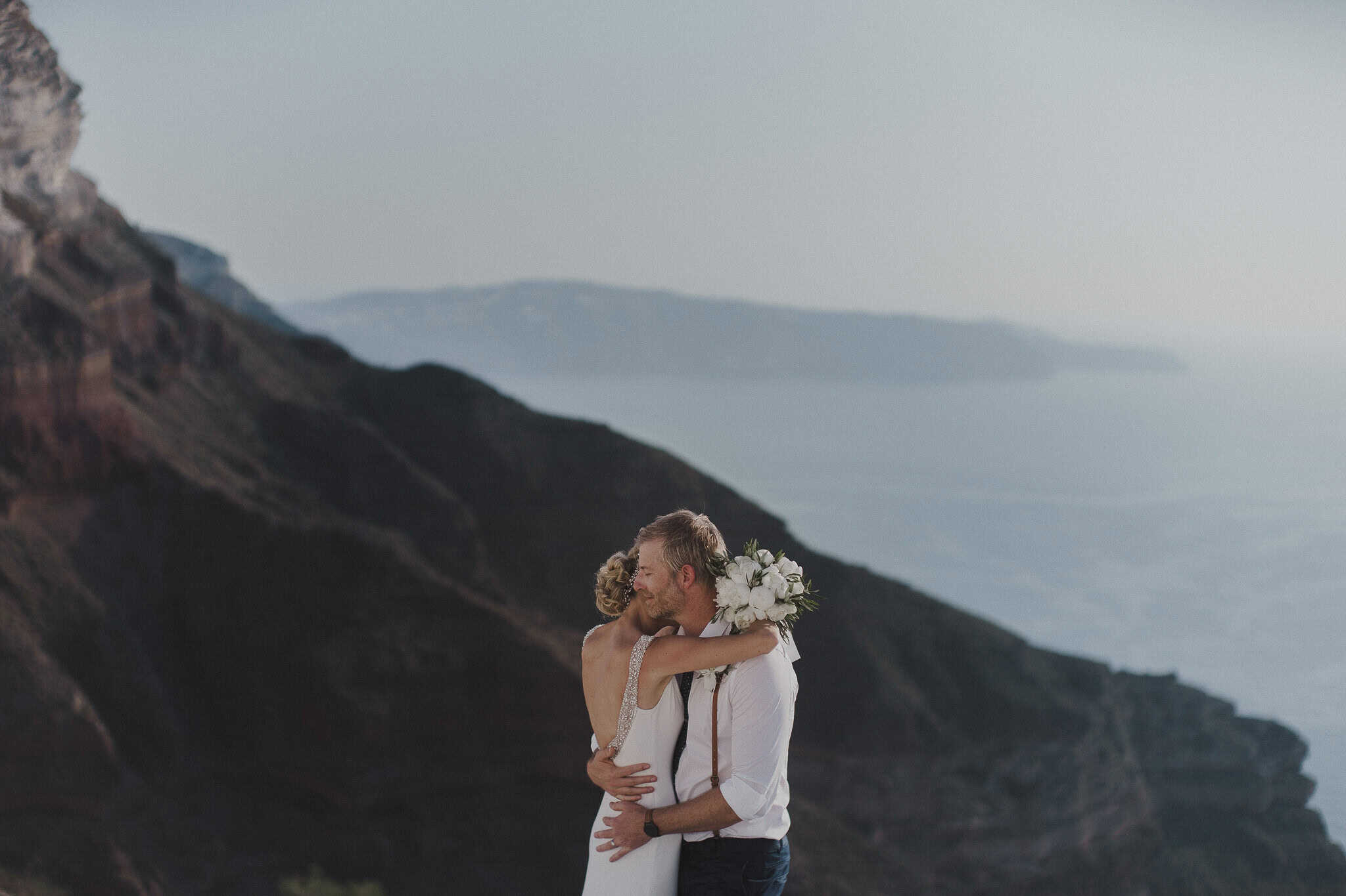 Newly weds embrace above the Caldera.