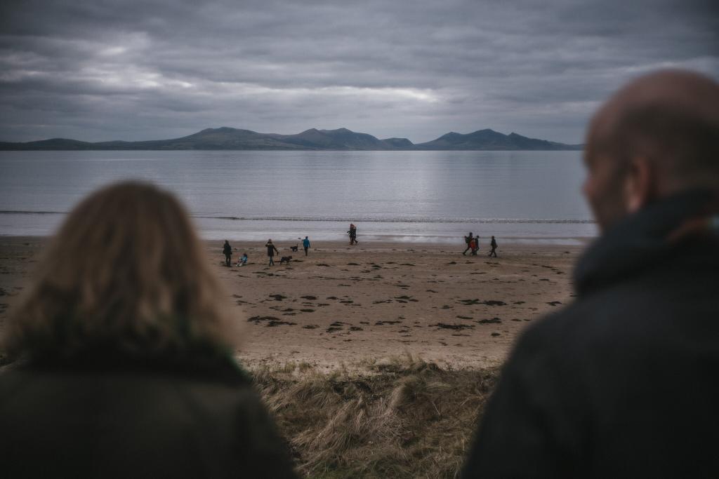 Looking across to Snowdonia from Newborough beach from an Anglesey Wedding Photographer