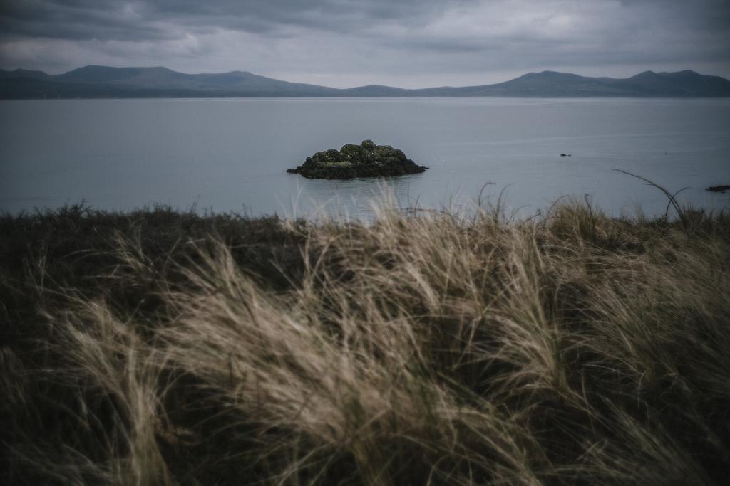 The view from Ynys Llanddwyn looking back to Snowdonia from an Anglesey Wedding Photographer