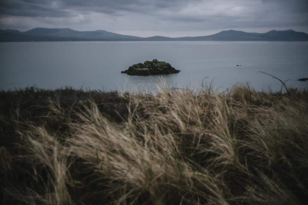 The view from Ynys Llanddwyn looking back to Snowdonia from an Anglesey Wedding Photographer