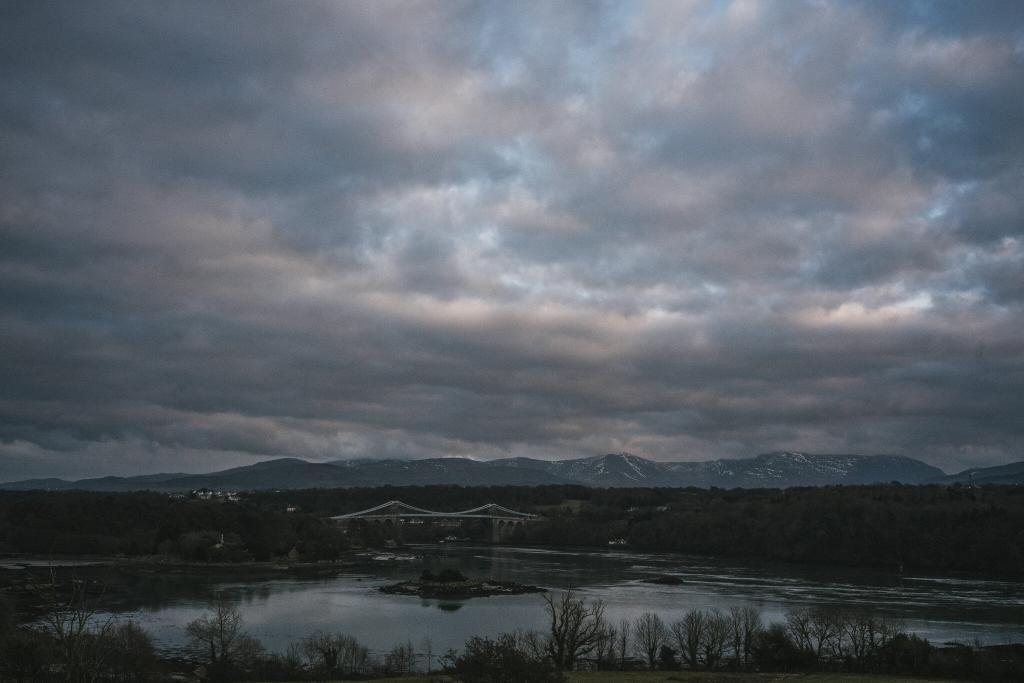 Menai Suspension Bridge at dusk. Photographed from the A5 layby on Anglesey. From an Anglesey Wedding Photographer