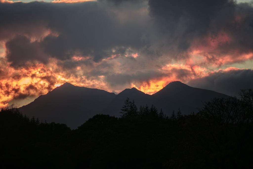 The sun sets behind Tryfan as viewed from Capel Curig from a North Wales Wedding Photographer