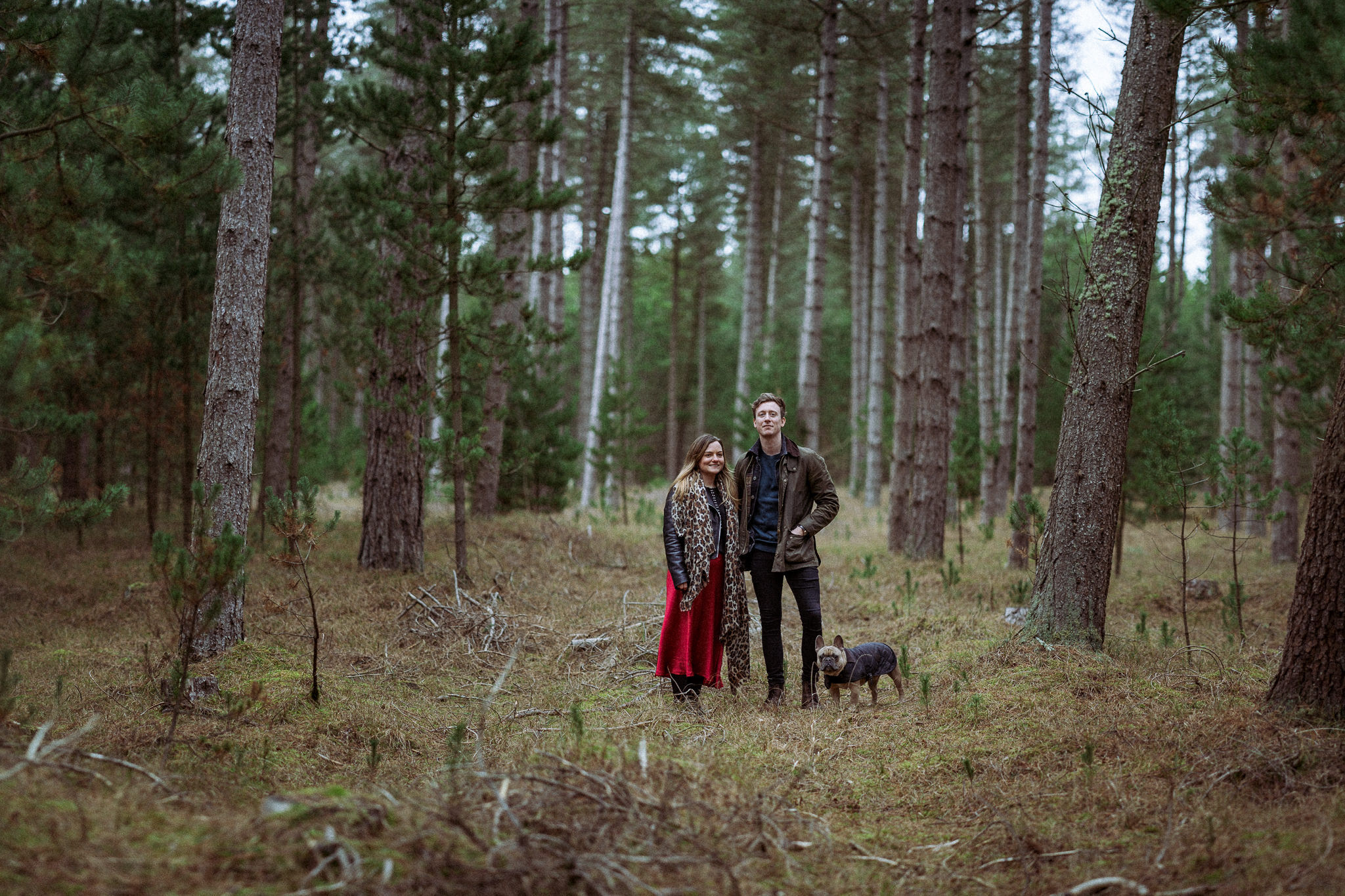 A couple and their dog pose for a picture in Newborough Forest, Anglesey.