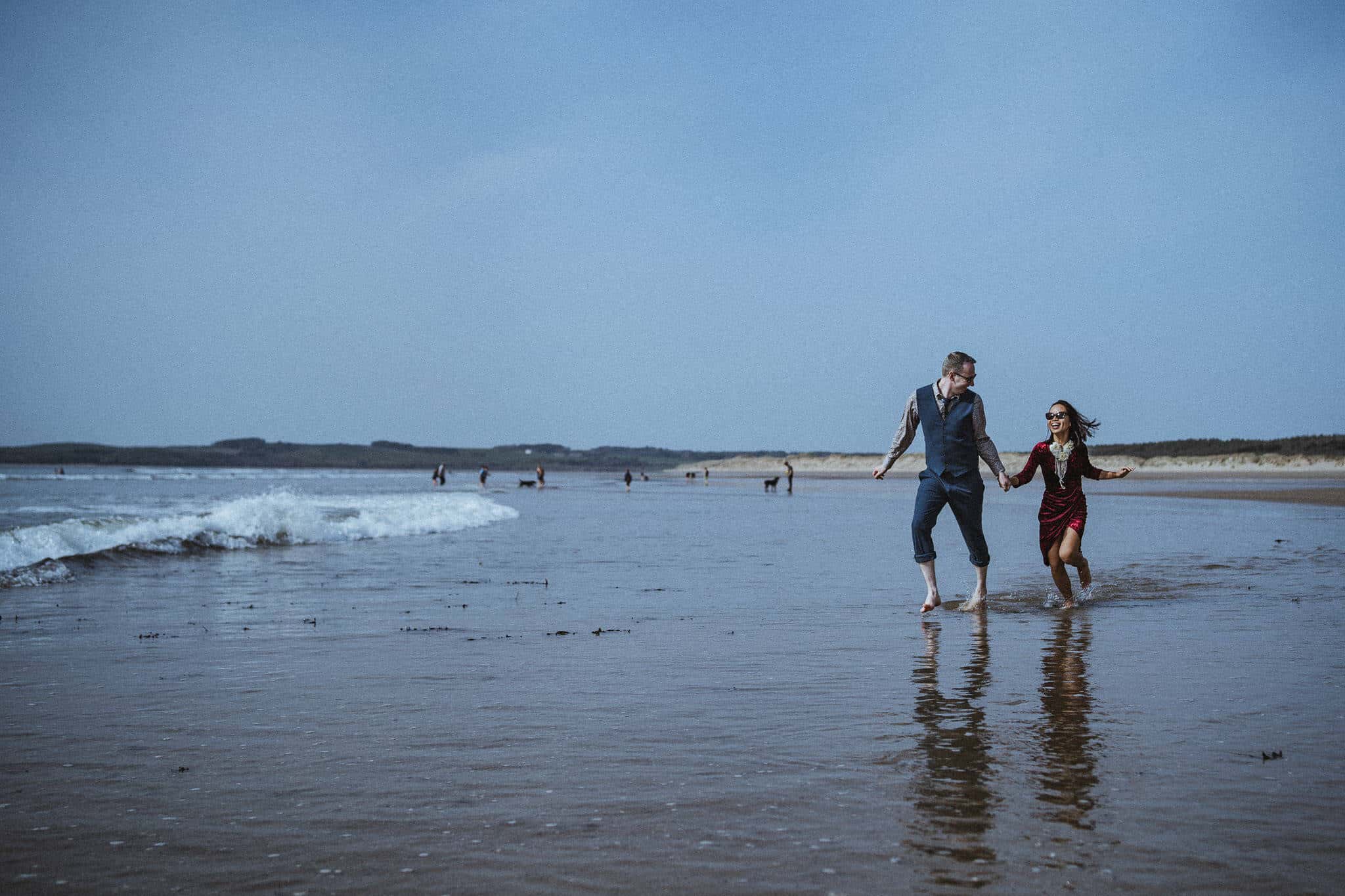 Splashing in the sea on Malltraeth Bay beach, Anglesey.